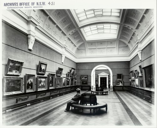 Man sitting in art gallery alone, circa late 1800s.